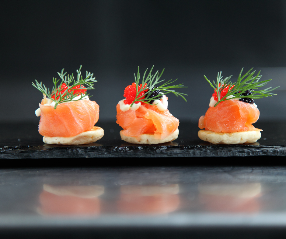 Salmon-canapés on a black board